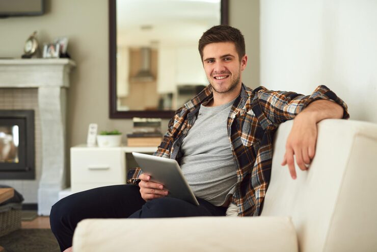 portrait-relax-tablet-with-man-sofa-living-room-home-app-browsing-social-media-internet-smile-technology-with-happy-person-apartment-comfort-weekend-time-off_590464-376161